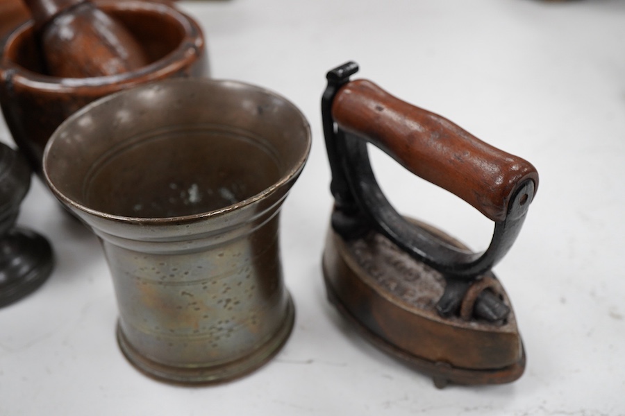 Sundry items to include a large pestle, spice grinder, flat iron on stand, bronze mortar and three other items, largest 42cm in length